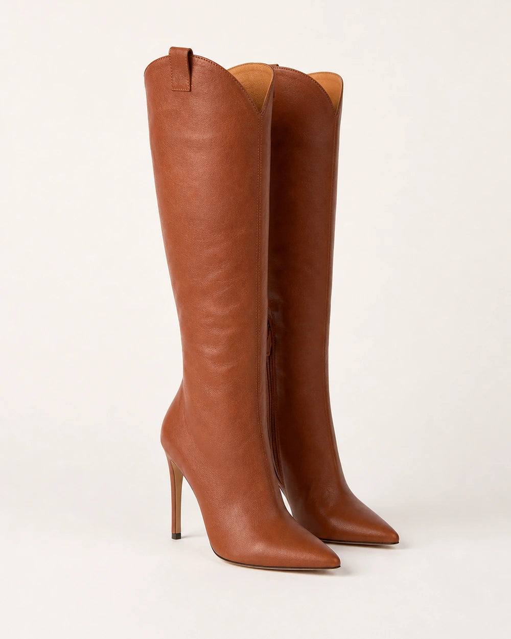 Women's brown leather pointed-toe knee-high boots with a high stiletto heel, hero view.
