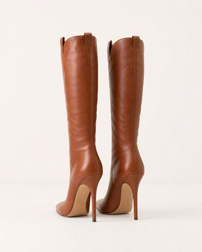 Women's brown leather knee-high stiletto boots, rear three-quarter view.