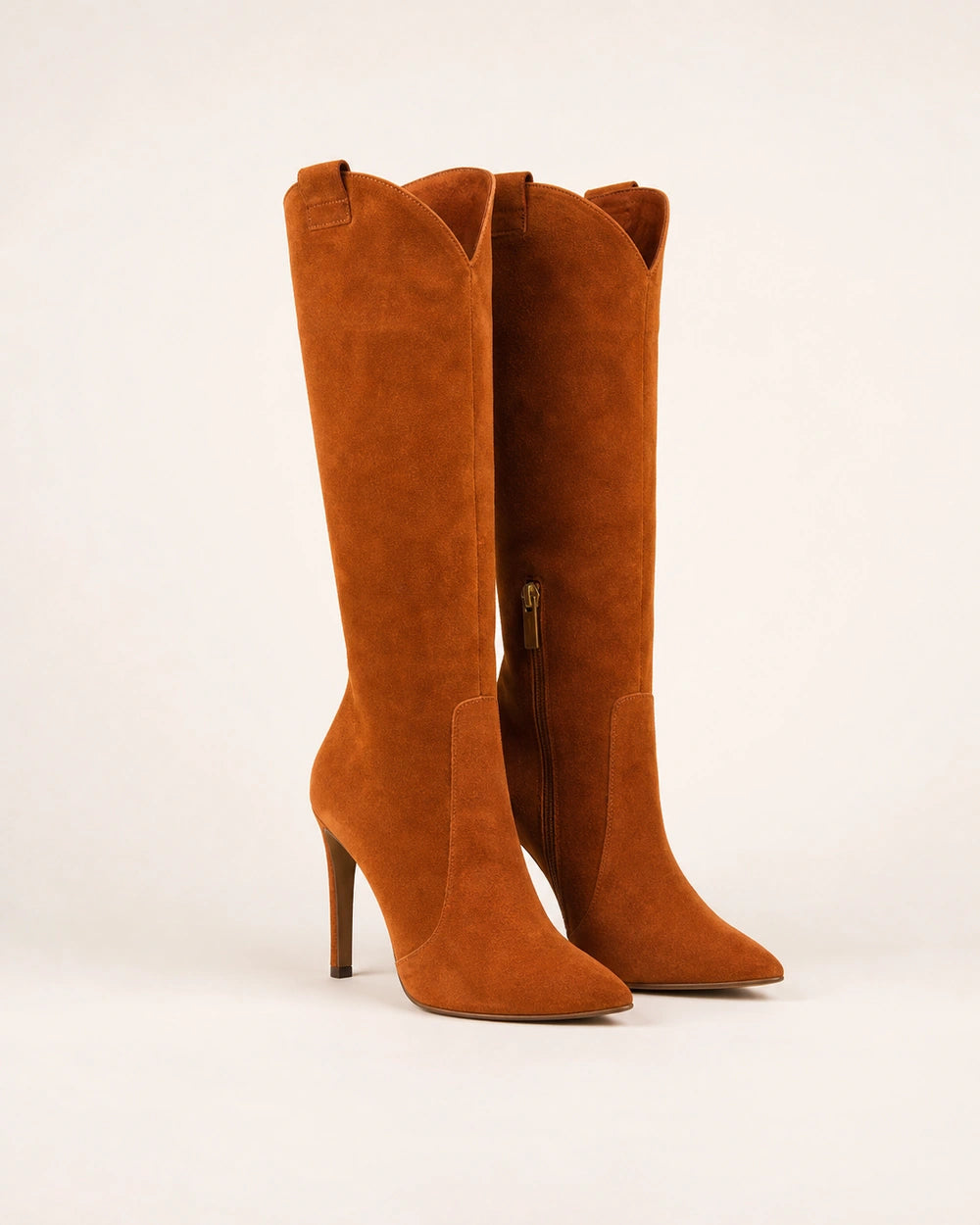 Women's brown suede pointed-toe knee-high boots with a high stiletto heel.
