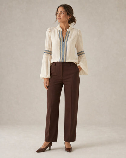 Women's ivory vintage blouse with embroidered trim, complete silhouette.