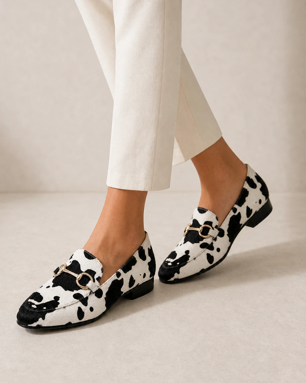 OCTAVIA-QUALITY-REMAKE-2026-07-22 — loafers-for-women-animal-print-slip-on-black-white-06-walking-view.webp