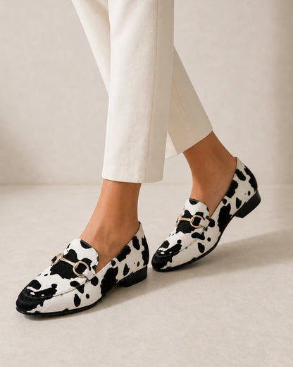 OCTAVIA-QUALITY-REMAKE-2026-07-22 — loafers-for-women-animal-print-slip-on-black-white-06-walking-view.webp